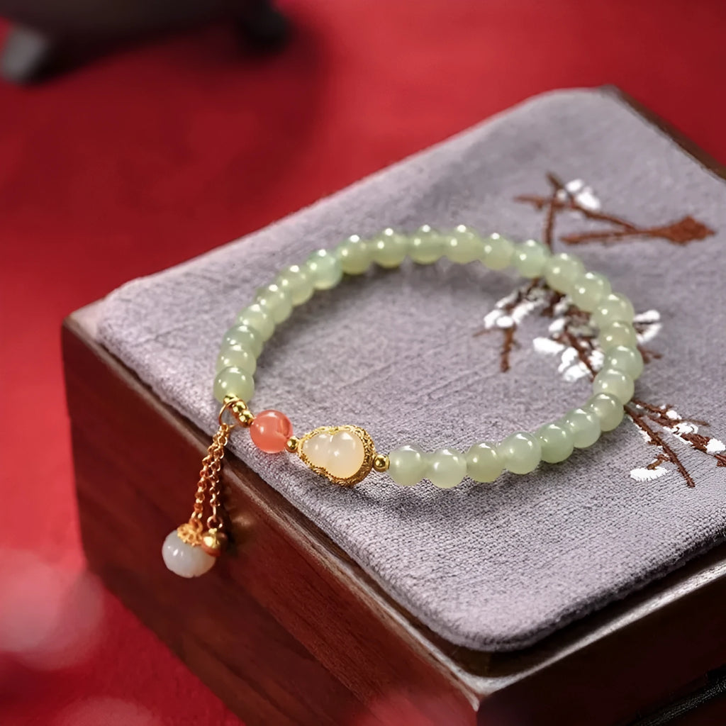 Jade women's bracelet with gold-plated gourd charm and fu character traditional design elements