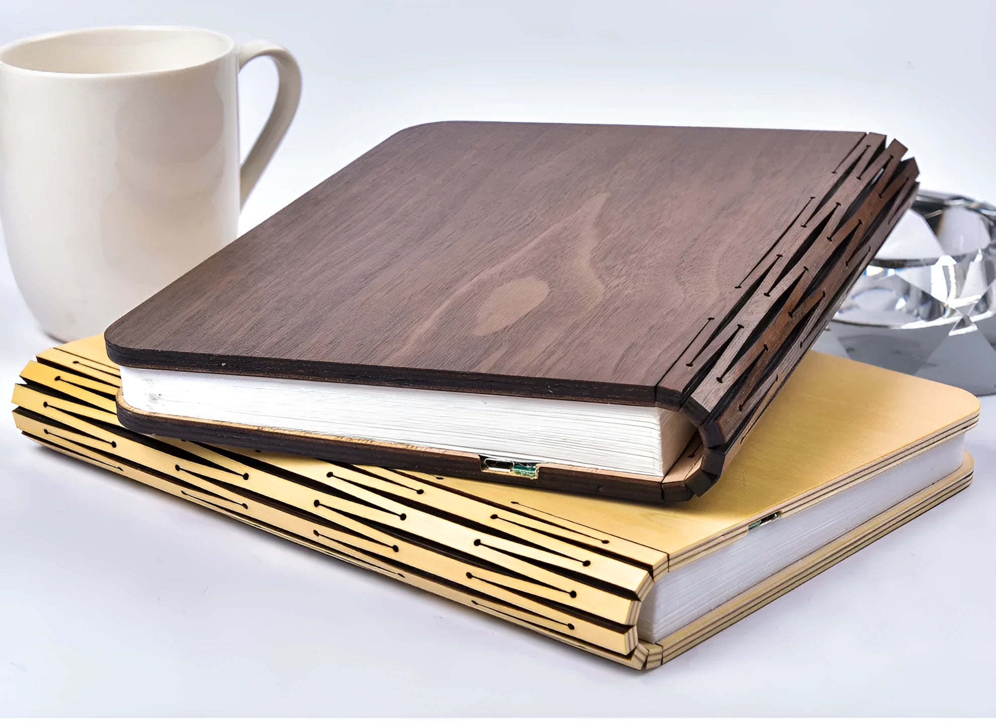 Walnut cover LED book light open at an angle showing white light pages on a surface