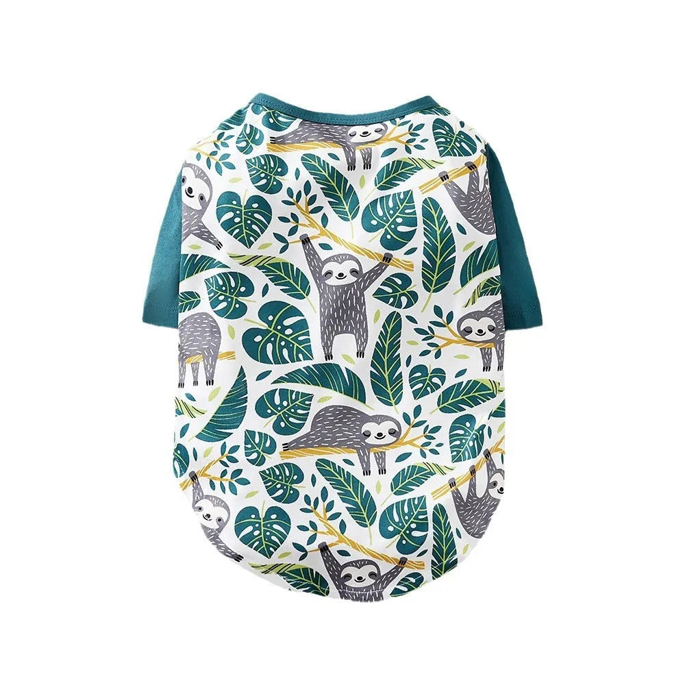 A small dog wearing a colourful, printed polyester t-shirt, showing the full chest design and fit.