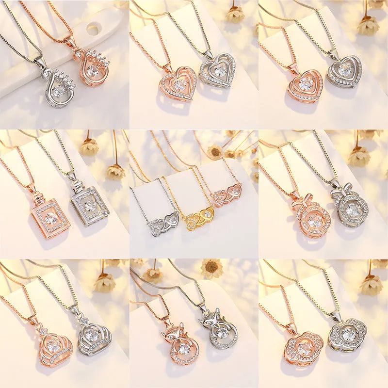 Silver tone heart pendant necklace with crown charm and bow detail on a delicate chain.