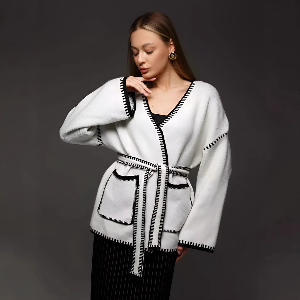 Loose mid-length knitted cardigan in camel colour on a hanger
