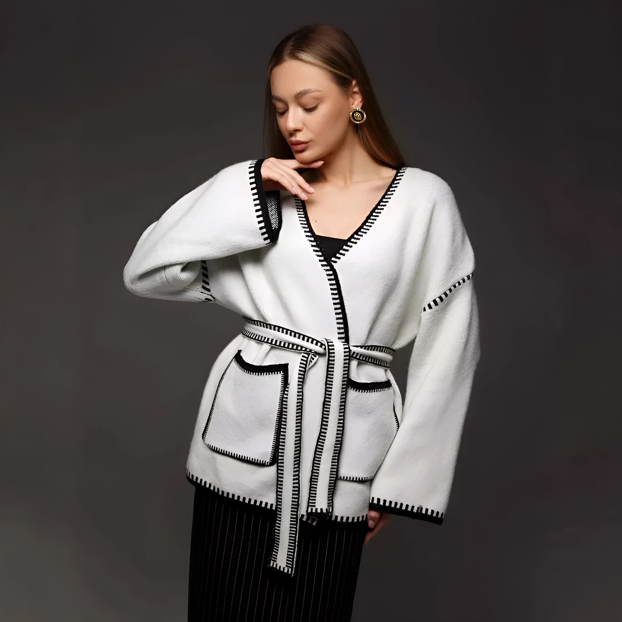 Loose mid-length knitted cardigan in camel colour on a hanger