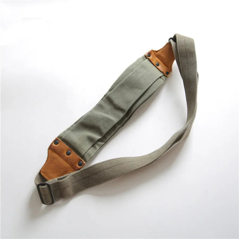 Green retro military style chest bag made of canvas with leather accents.