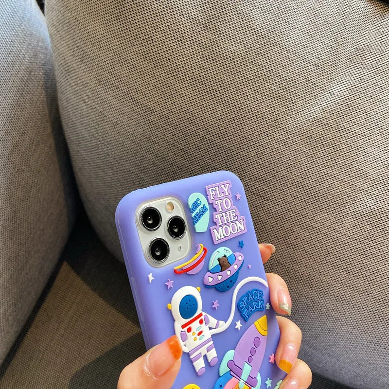 Purple silicone iPhone case with a cartoon astronaut graphic, showing front and back views.