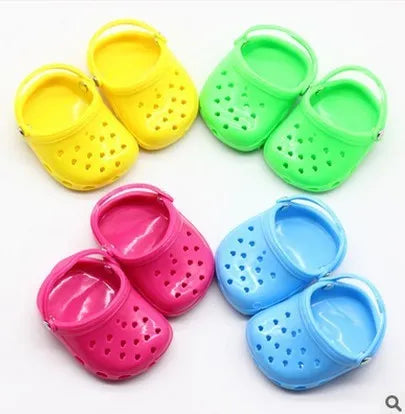 Plastic doll beach slippers accessory in blue, red, yellow, and green colours for fashion dolls