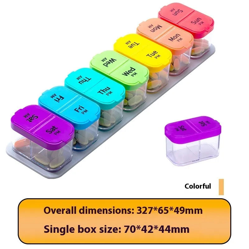 Large white and rainbow coloured plastic pill box with 14 removable compartments open on a table.