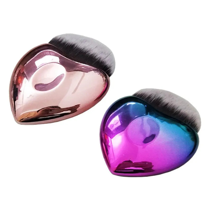 Heart-shaped portable foundation brush with soft bristles for blush and contour application, on a clean background