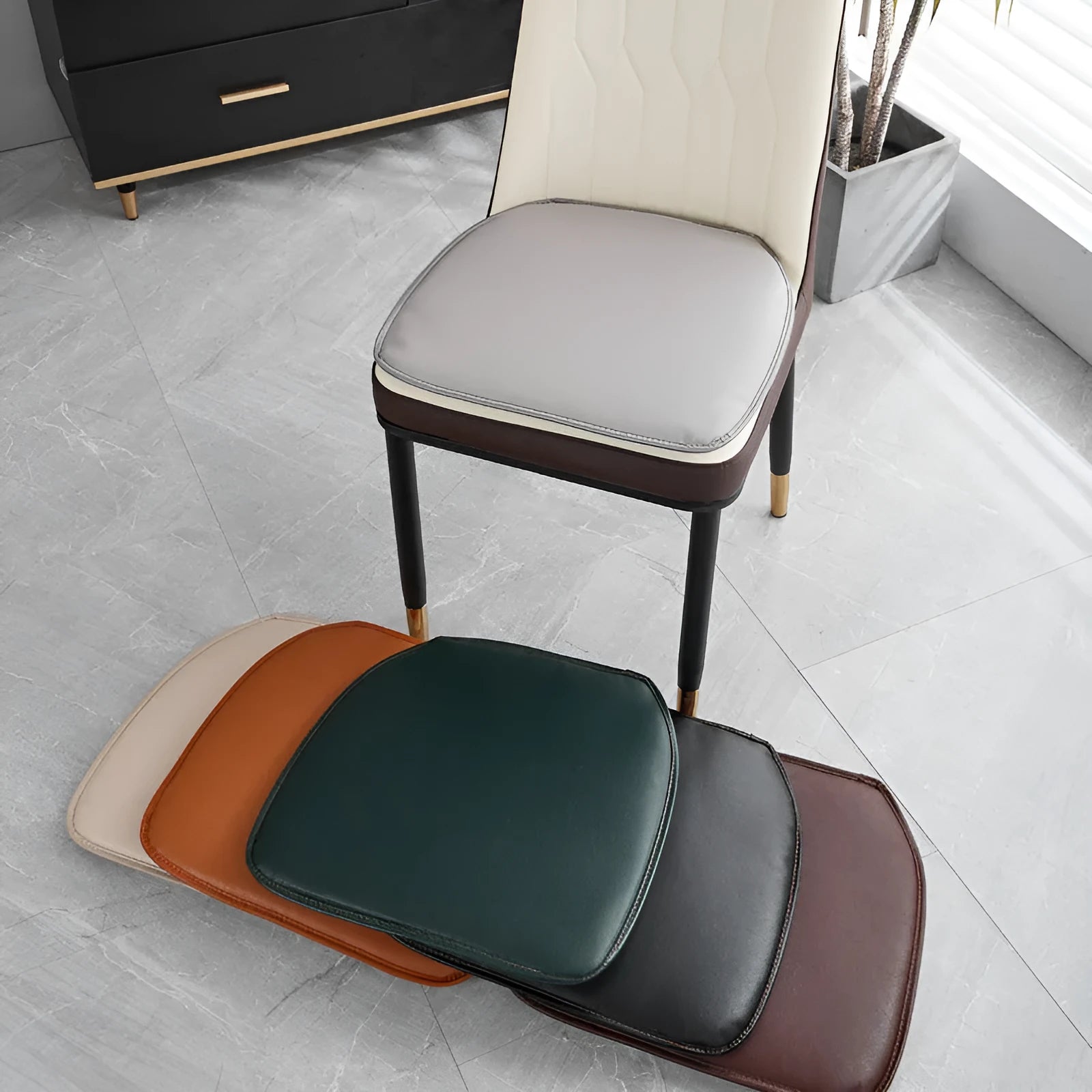 Orange leather horseshoe-shaped seat cushion on a wooden dining chair.