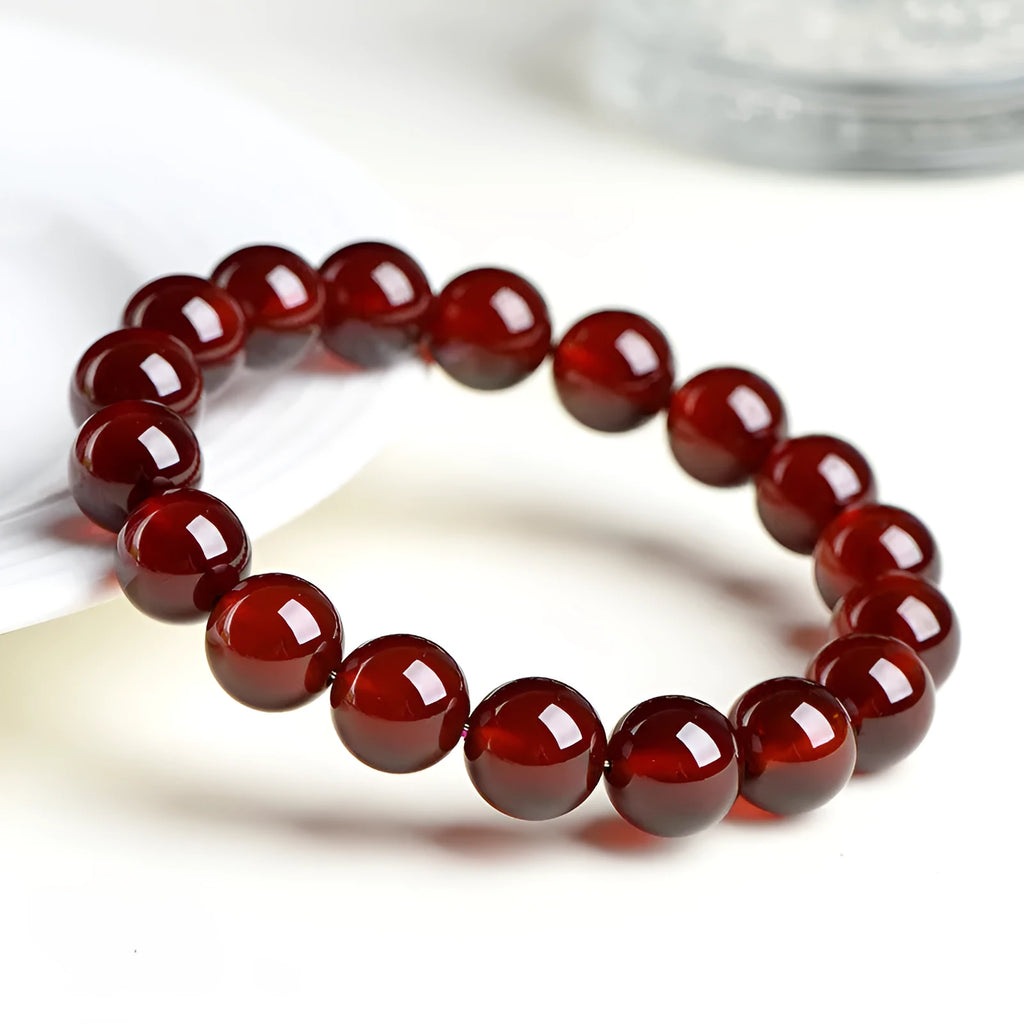 Natural orange red garnet ball bracelet with Ruyi design elements on crystal beads