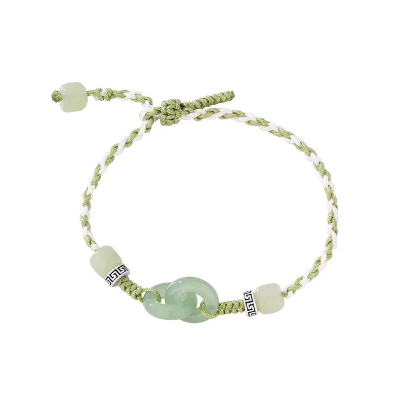 Green adjustable bracelet with jade peace buckle and copper zodiac charm.