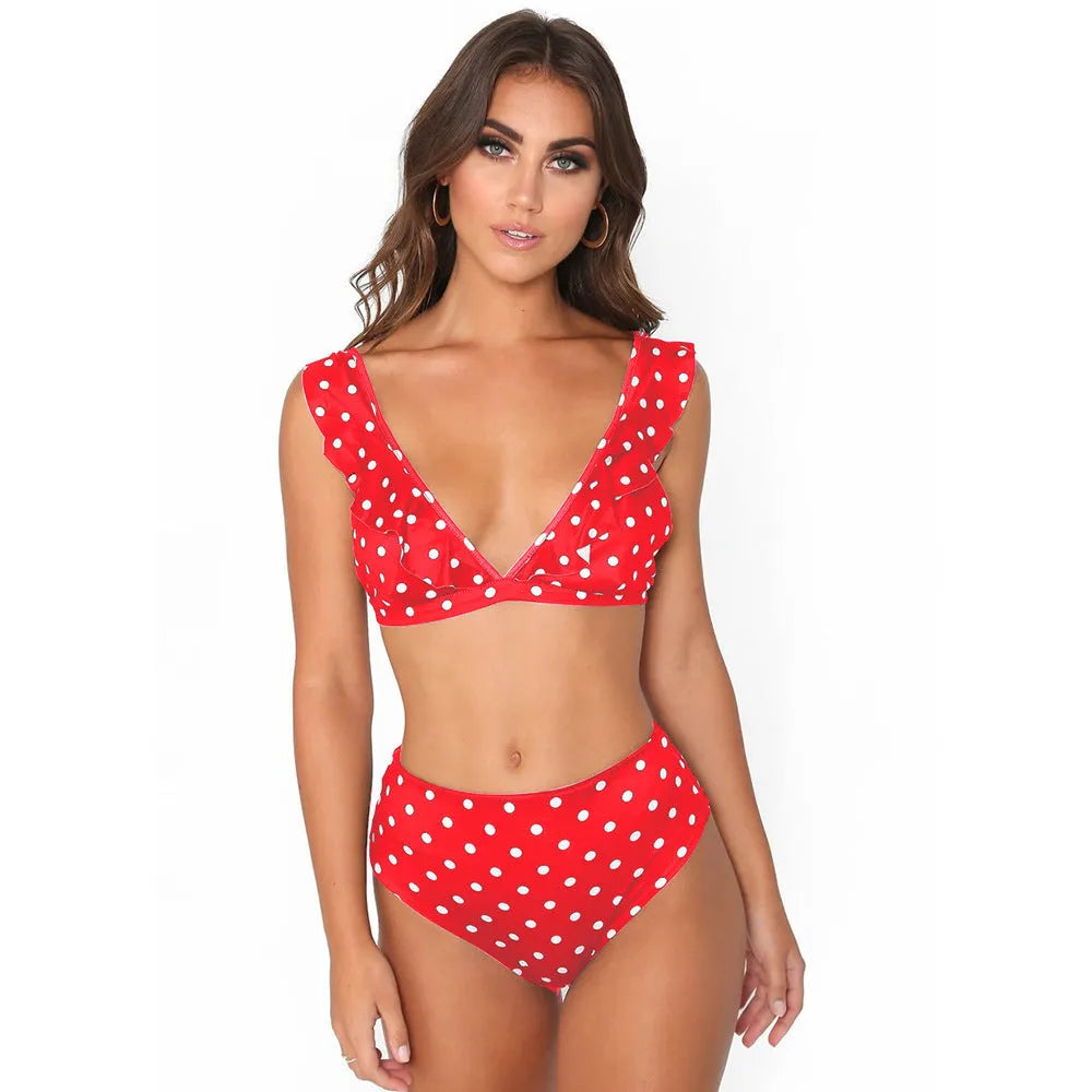 Black and white polka dot print swimsuit with ruffled detailing and deep V-neck