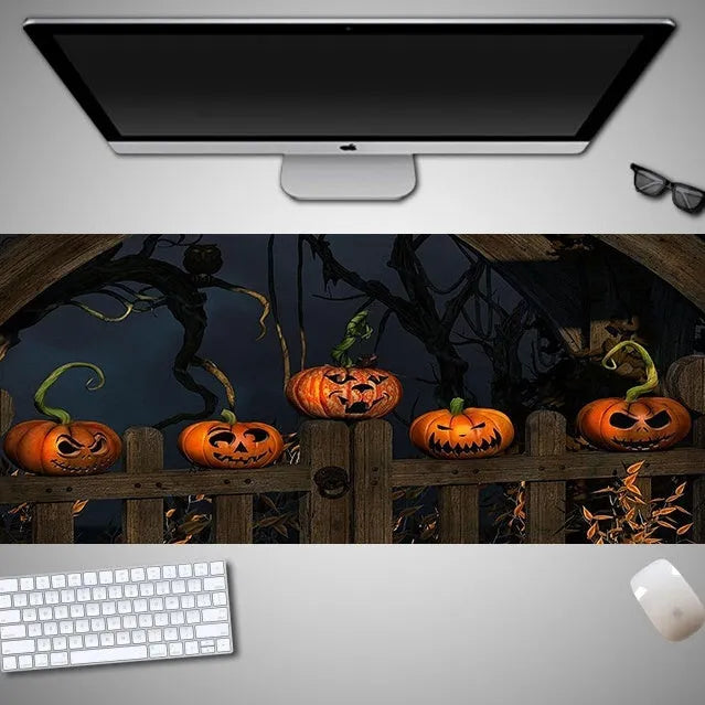 Oversized Halloween-themed gaming mouse pad with non-slip rubber base on a desktop
