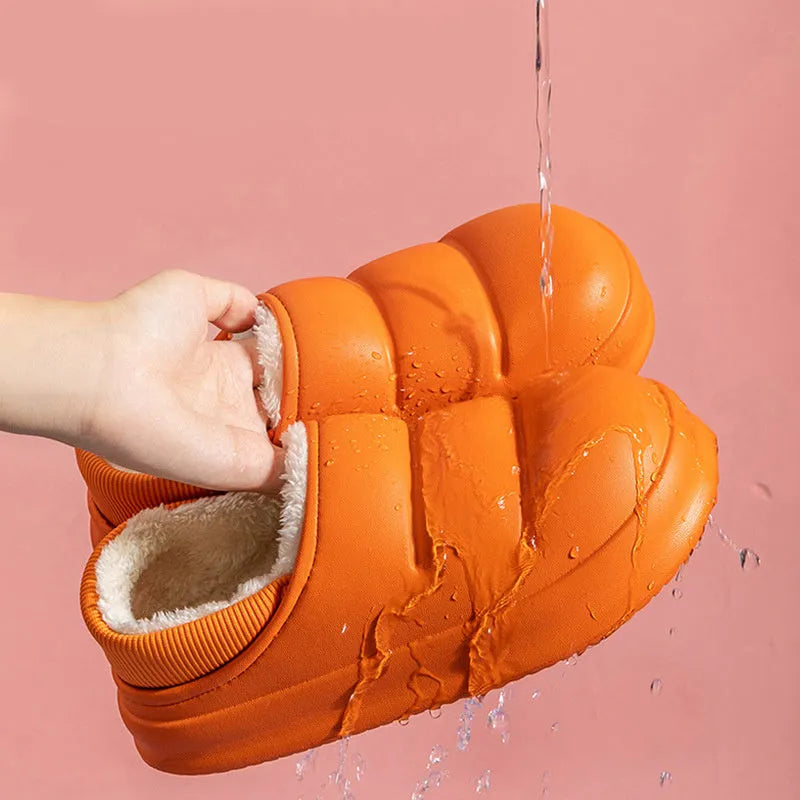 Yellow women's EVA overshoe slippers with plush lining and a textured non-slip sole on a wooden deck.