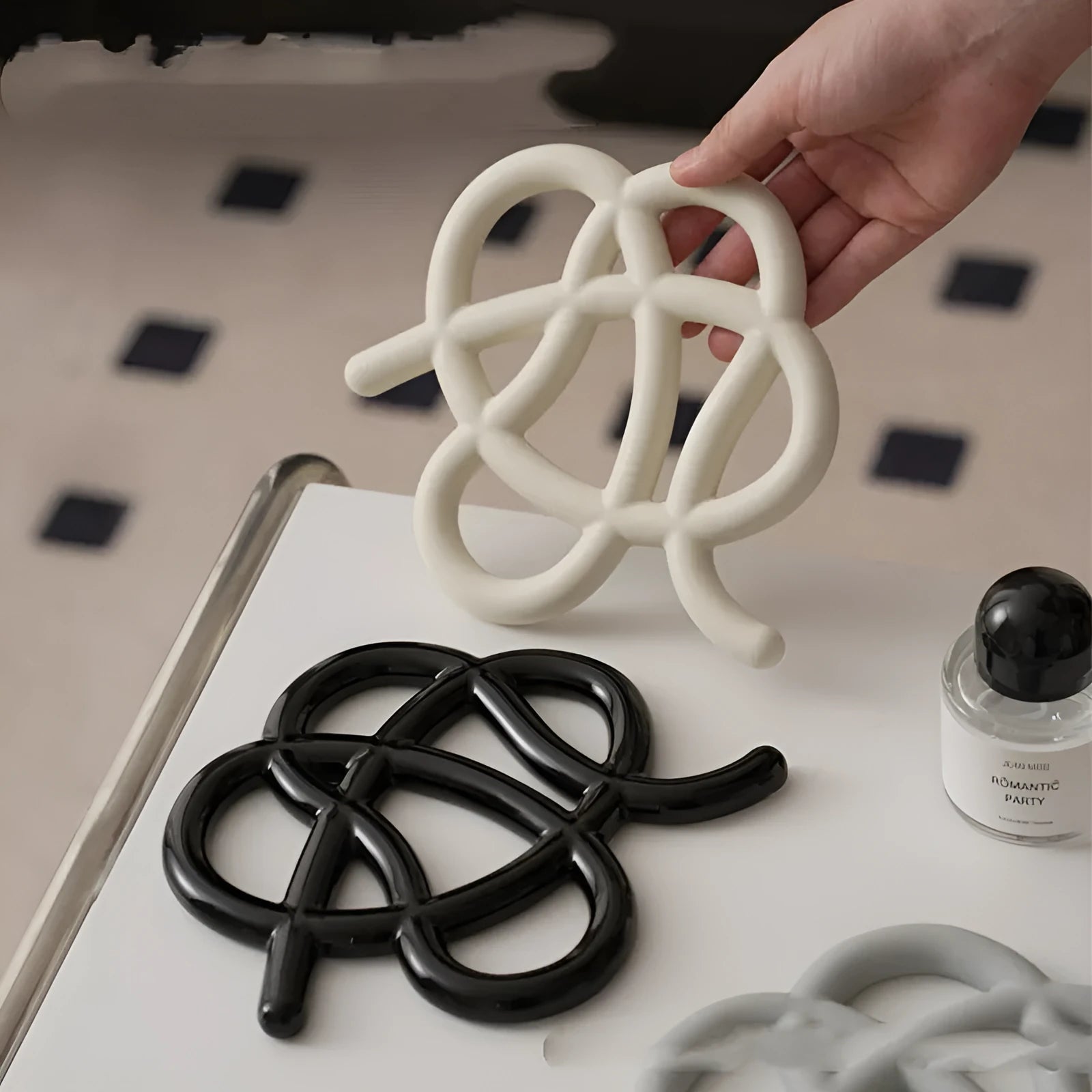 Ceramic heatproof mat in an irregular shape on a kitchen countertop.