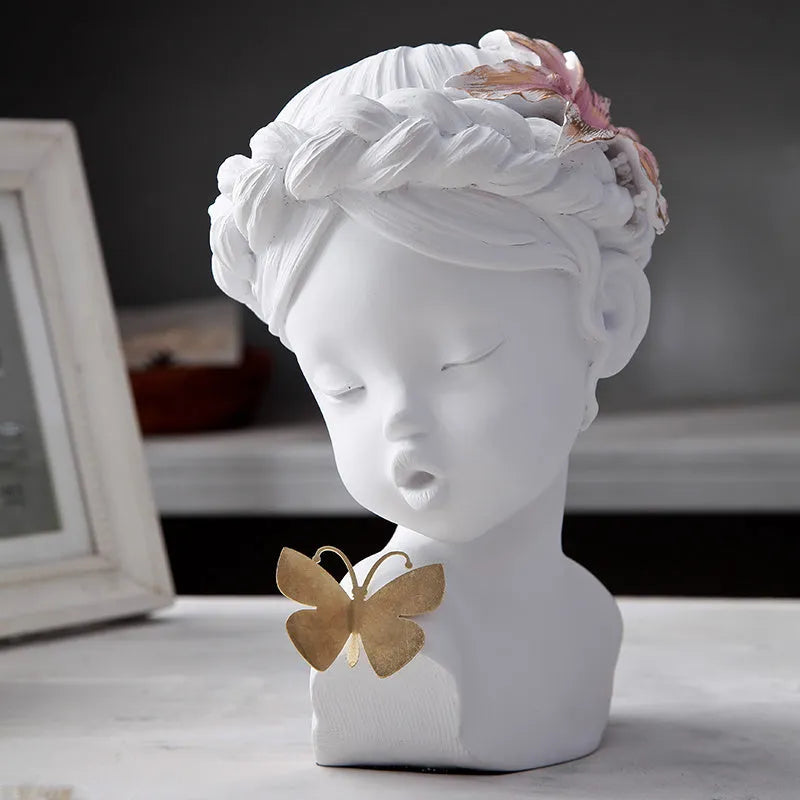 Nordic style resin character figurine in light blue and white on a desktop