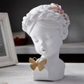 Nordic style resin character figurine in light blue and white on a desktop