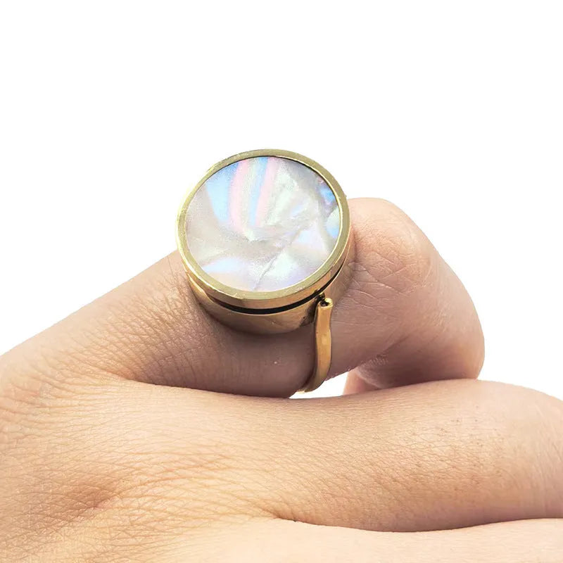 Gold electroplated titanium steel unisex storage ring with future-style round design on a plain background