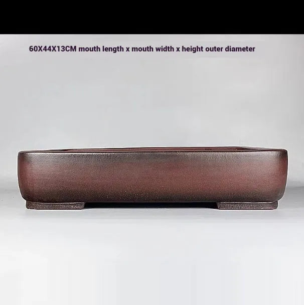 Handmade rectangular purple clay flower pot with antique finish showing internal planting space