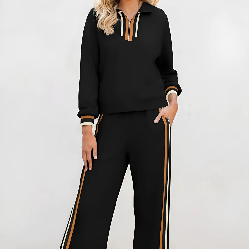 Black striped patchwork quarter zip pullover and loose pant set on a model, showing loose fit and striped detailing.