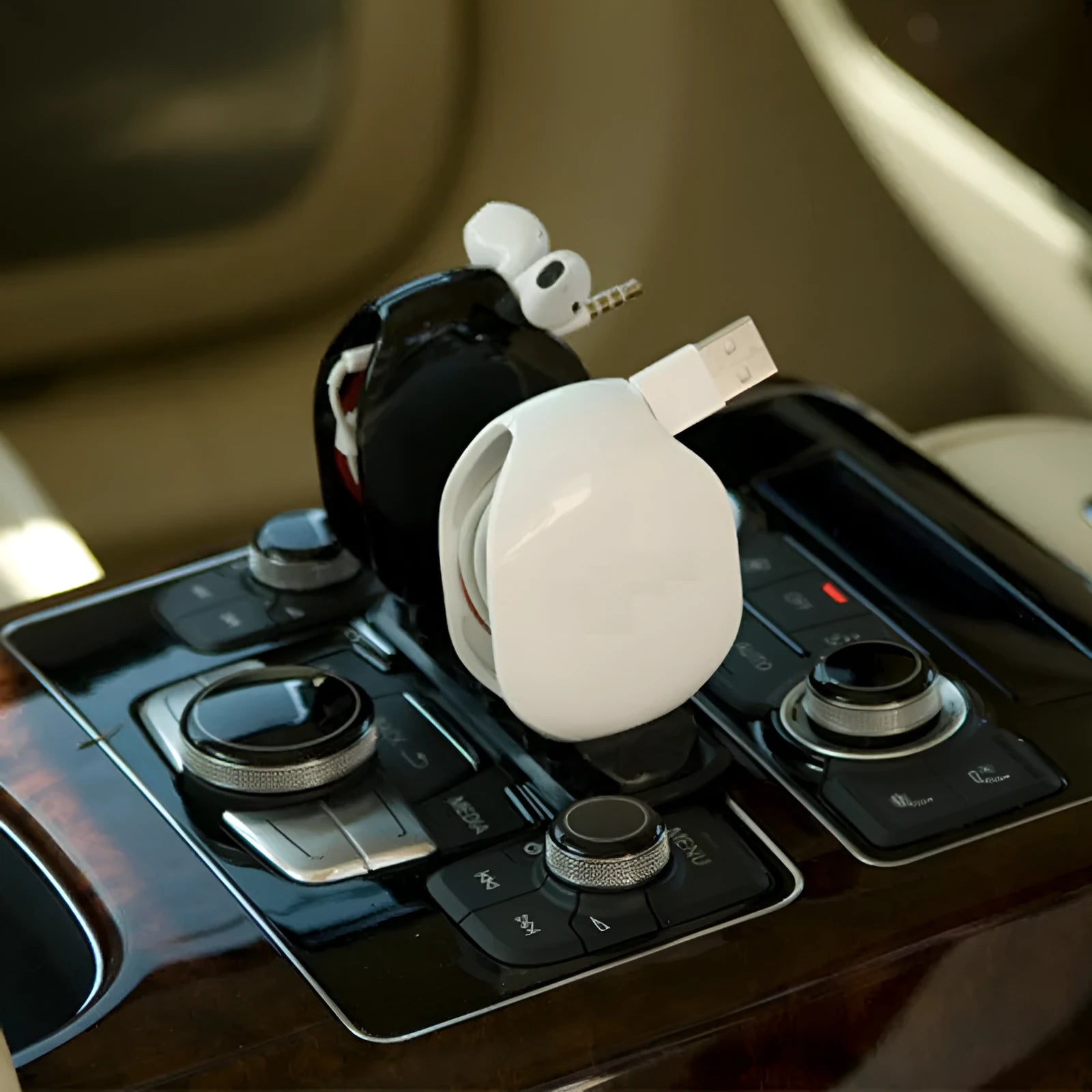 Automatic earphone cable retractor winder in multiple colours on a white background.