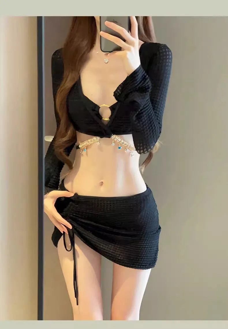 Women's black long sleeve bikini swimsuit made from polyester fabric for swimming.