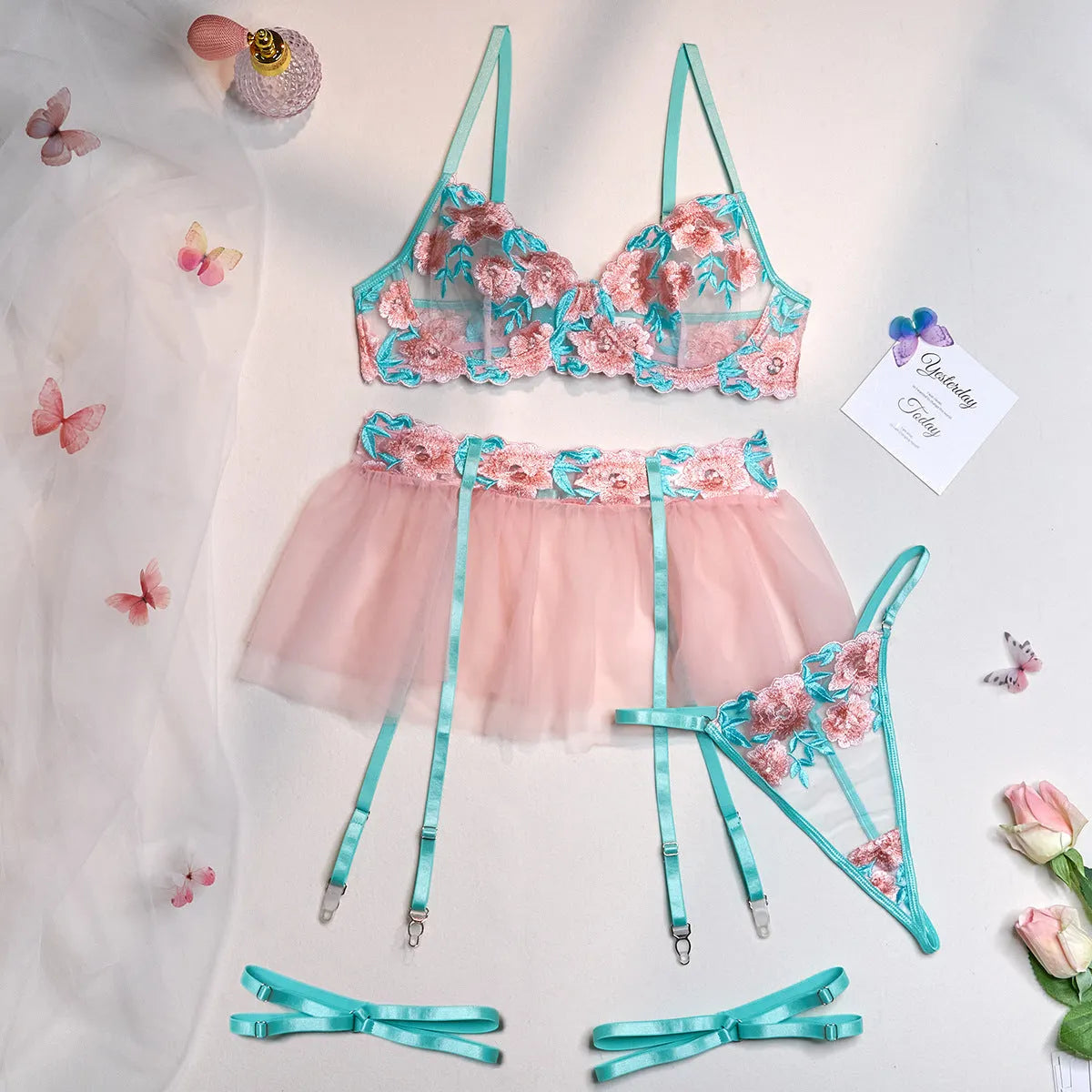 Pink women's mesh pettiskirt bikini set with embroidery detail on polyester fabric.