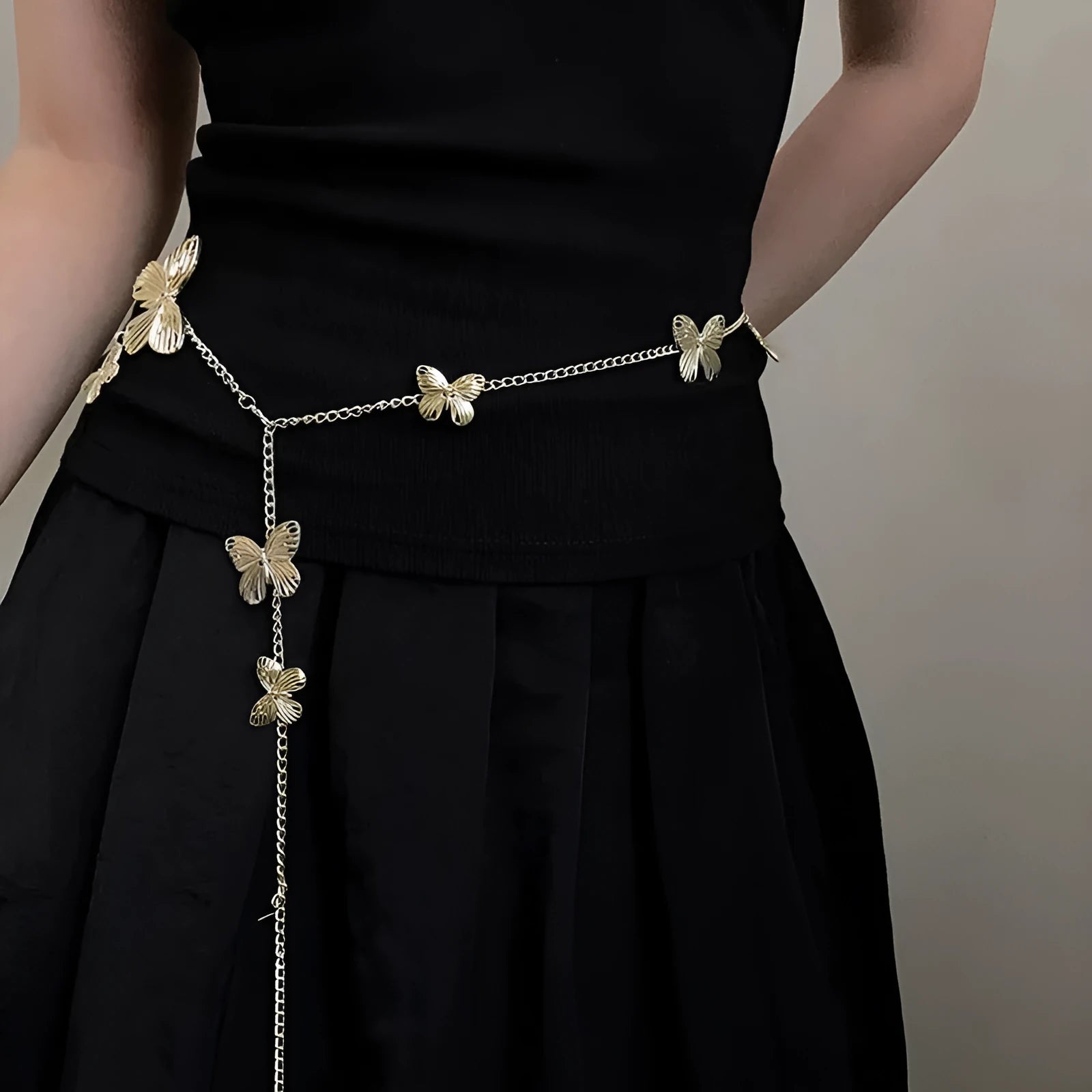 Gold butterfly waist chain for women, 104cm long and 40mm wide, shown laid flat.