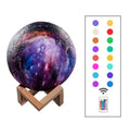 3D-printed white lunar sphere LED night light on a dark surface, showing touch and remote control.