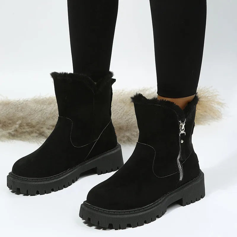 Women's black faux suede high-top snow boots with side zip and thick faux fur lining visible at the ankle.