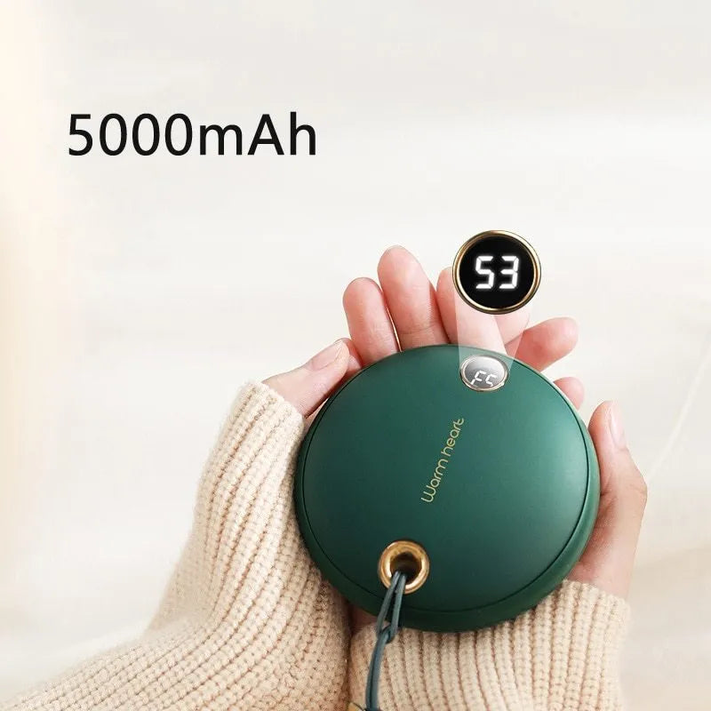Green portable hand warmer power bank with digital display showing 5000mAh capacity