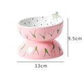 Orange patterned ceramic raised cat bowl on a tilted stand for food and water.
