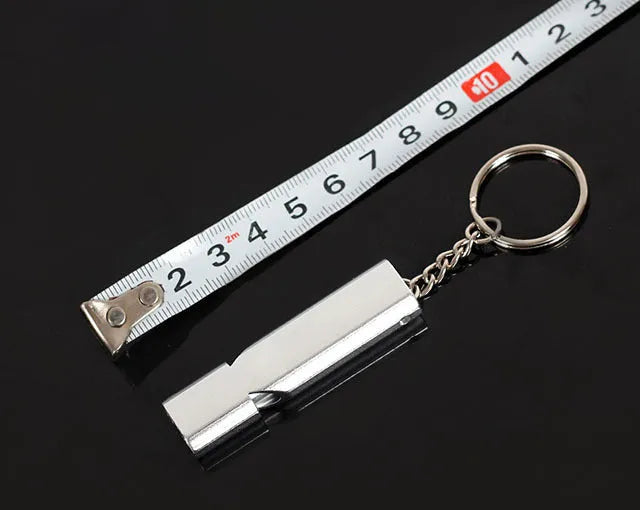 Silver and gold coloured aluminium alloy double-hole outdoor survival whistle with keychain.