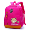 Blue nursery backpack with a cartoon bear design, showing front zip pocket and adjustable padded straps.