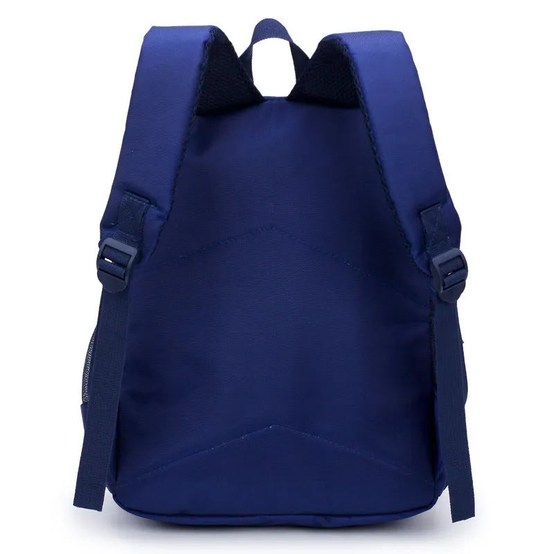Blue nursery backpack with a cartoon bear design, showing front zip pocket and adjustable padded straps.