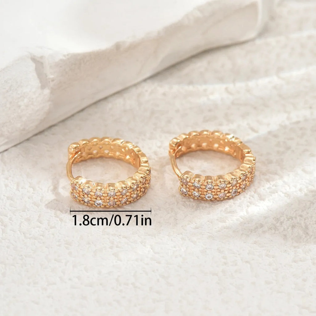 A pair of copper geometry pattern ear studs with round, dot and ring designs in colour DE20288.