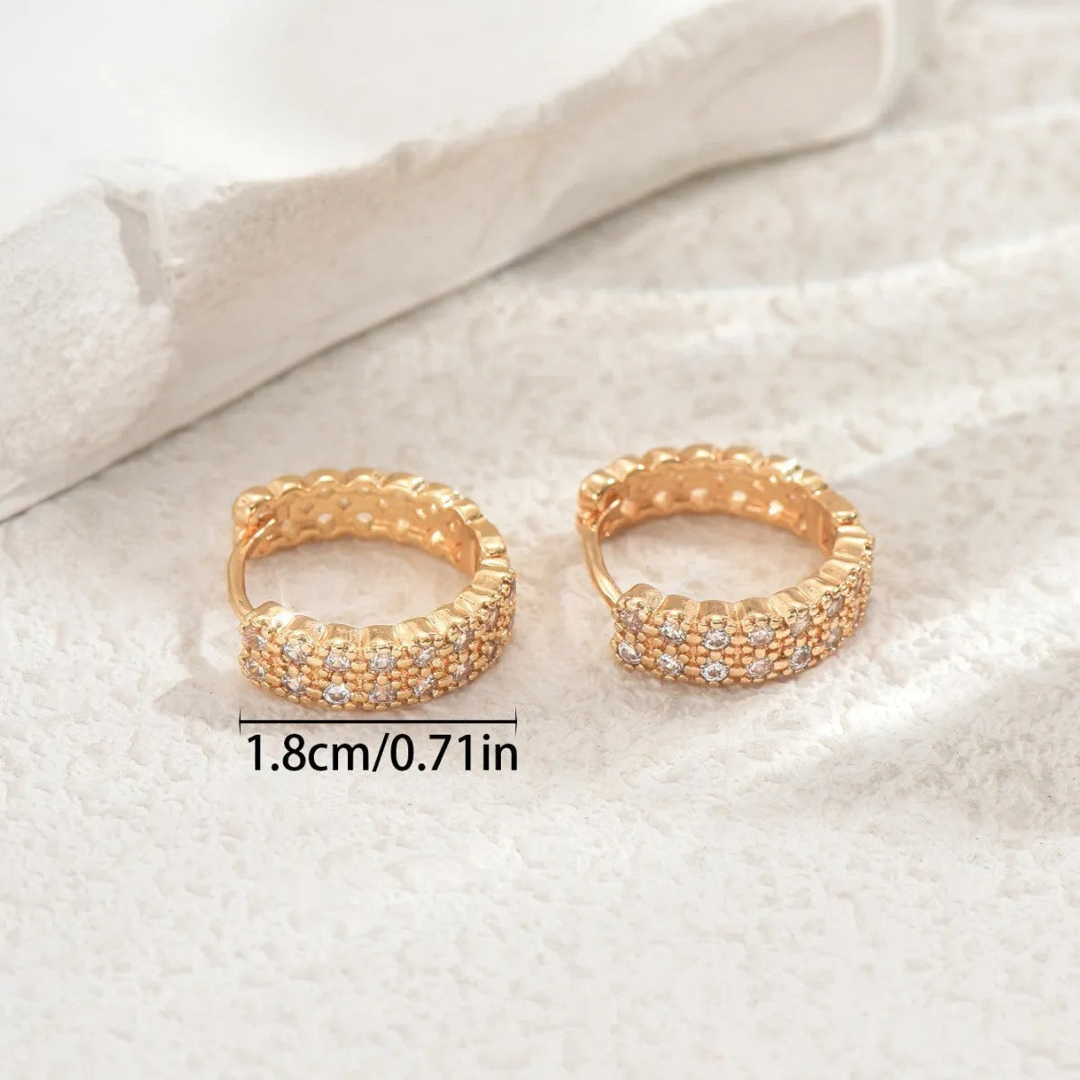 A pair of copper geometry pattern ear studs with round, dot and ring designs in colour DE20288.