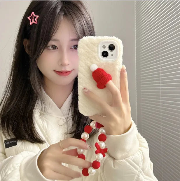 Red silicone phone case with plush Christmas hat bracelet for iPhone on white background