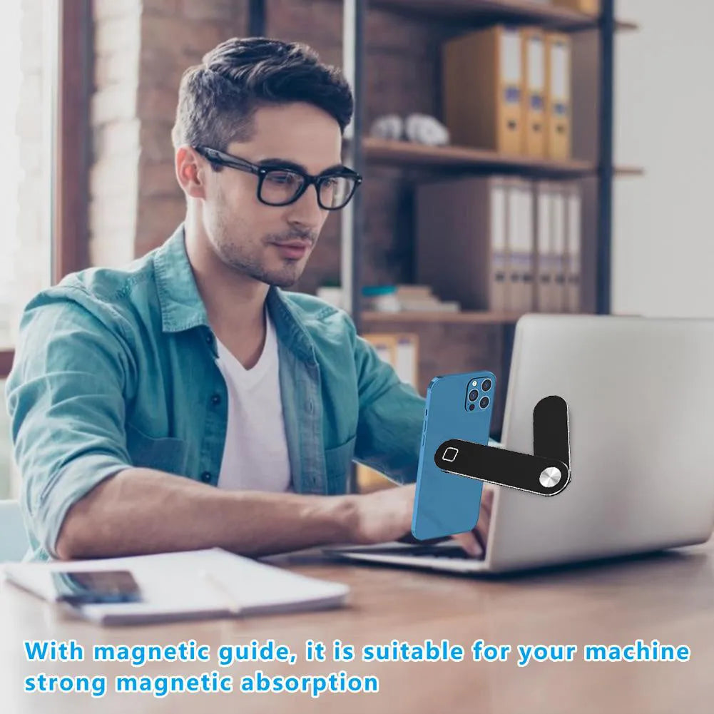 Black aluminium laptop phone holder with magnetic clip attached to laptop edge holding a smartphone