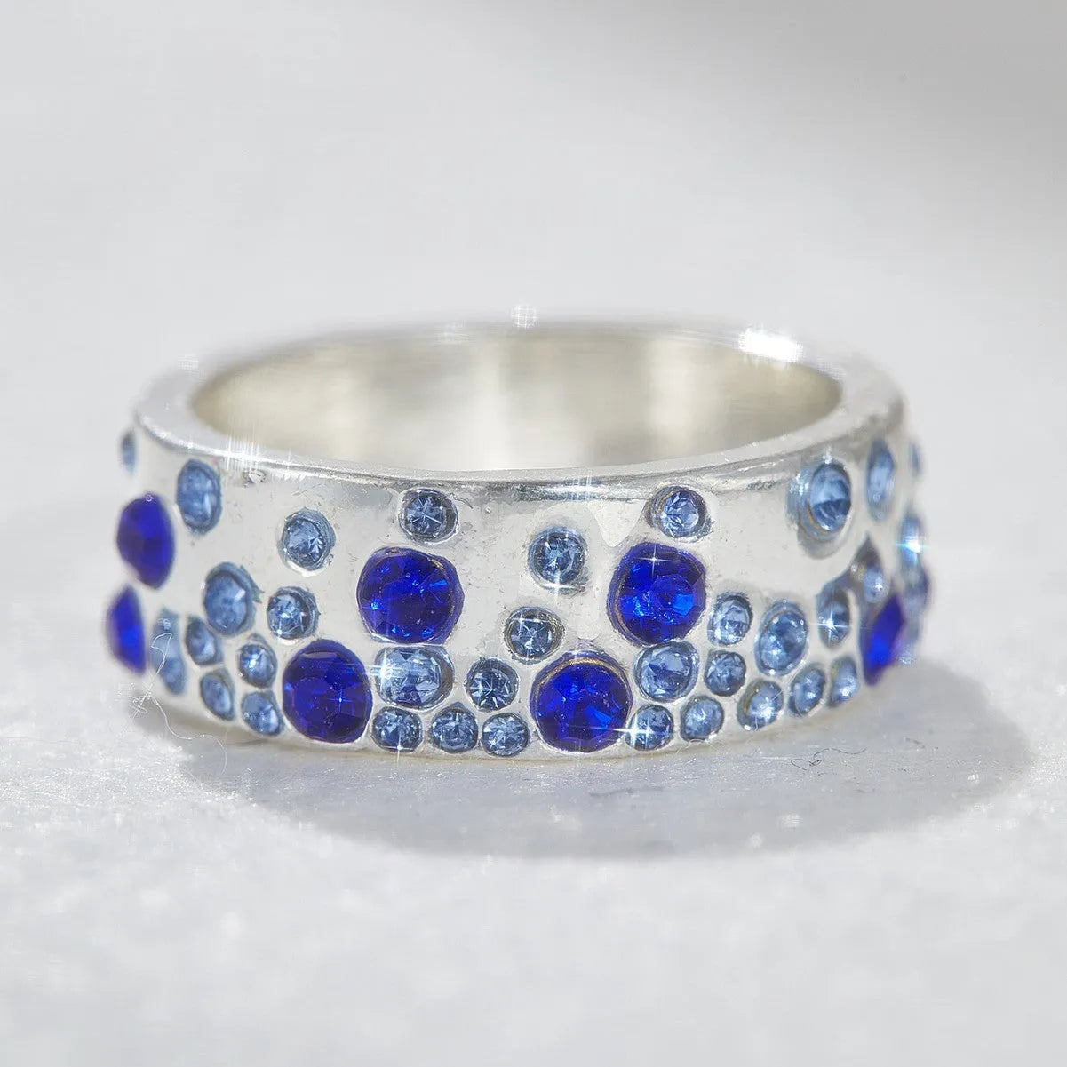 Mixed colour diamond retro personality ring in unisex geometric style on a white background.