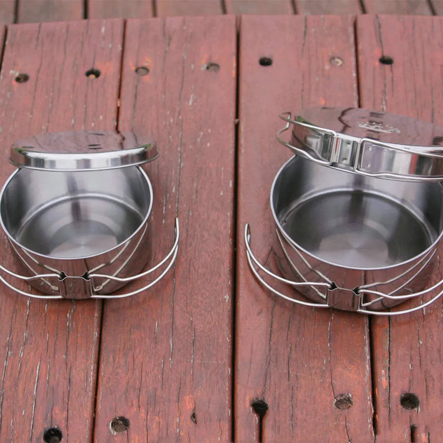 Stainless steel outdoor camping cookware set showing four round silver pots designed for 2-3 people