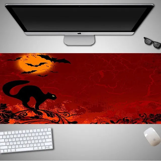 Oversized Halloween-themed gaming mouse pad with non-slip rubber base on a desktop