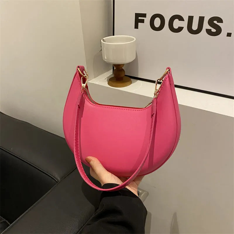 Round green one-shoulder underarm bag showing sewing line detailing and sandwich pocket design