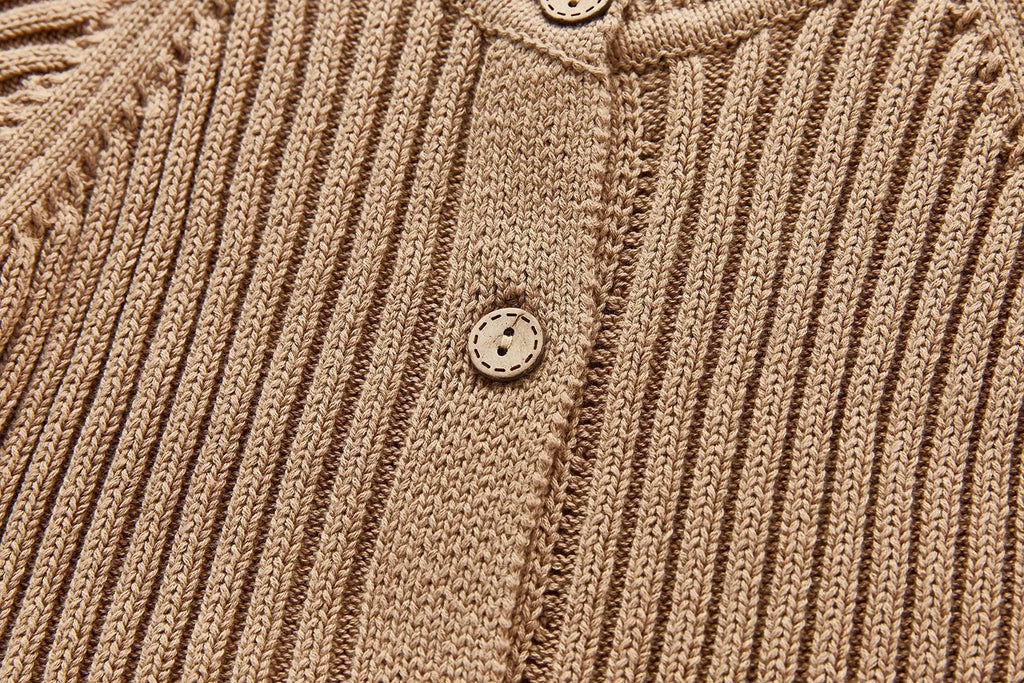 Baby long-sleeved knitted jumpsuit romper pullover in beige, size 80cm, lying flat on a white background