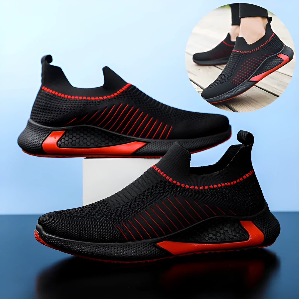 Men's black and white striped mesh slip-on sneakers with flyknit upper and low-cut profile.