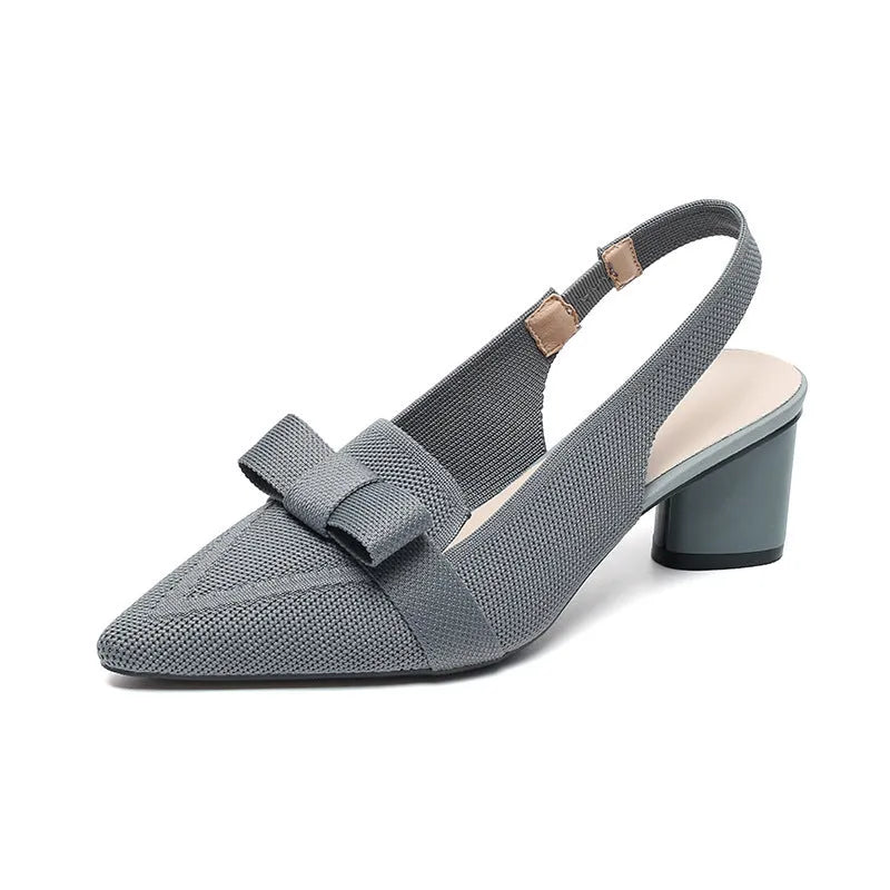 Women's closed toe high heel sandals with bow detail, ankle buckle strap, and pointed toe in a solid colour.
