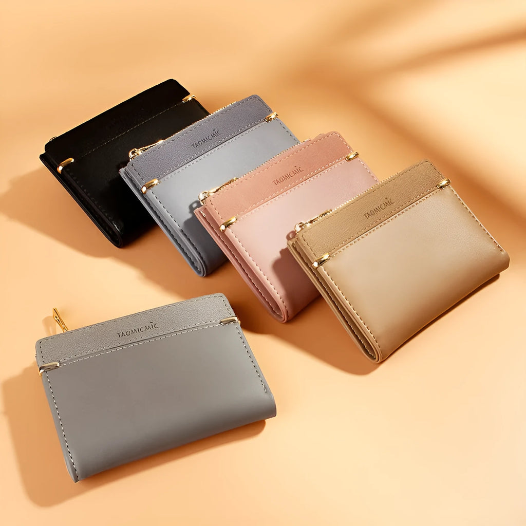 Black ladies bi-fold wallet with a gold zipper, open to show multiple card slots and a coin compartment.