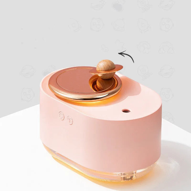 Green rotating planet humidifier with USB cable on desk showing night light illumination