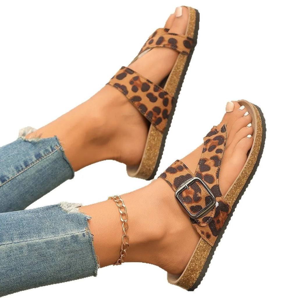 Leopard print Roman style slippers with toe covering and wooden sole.