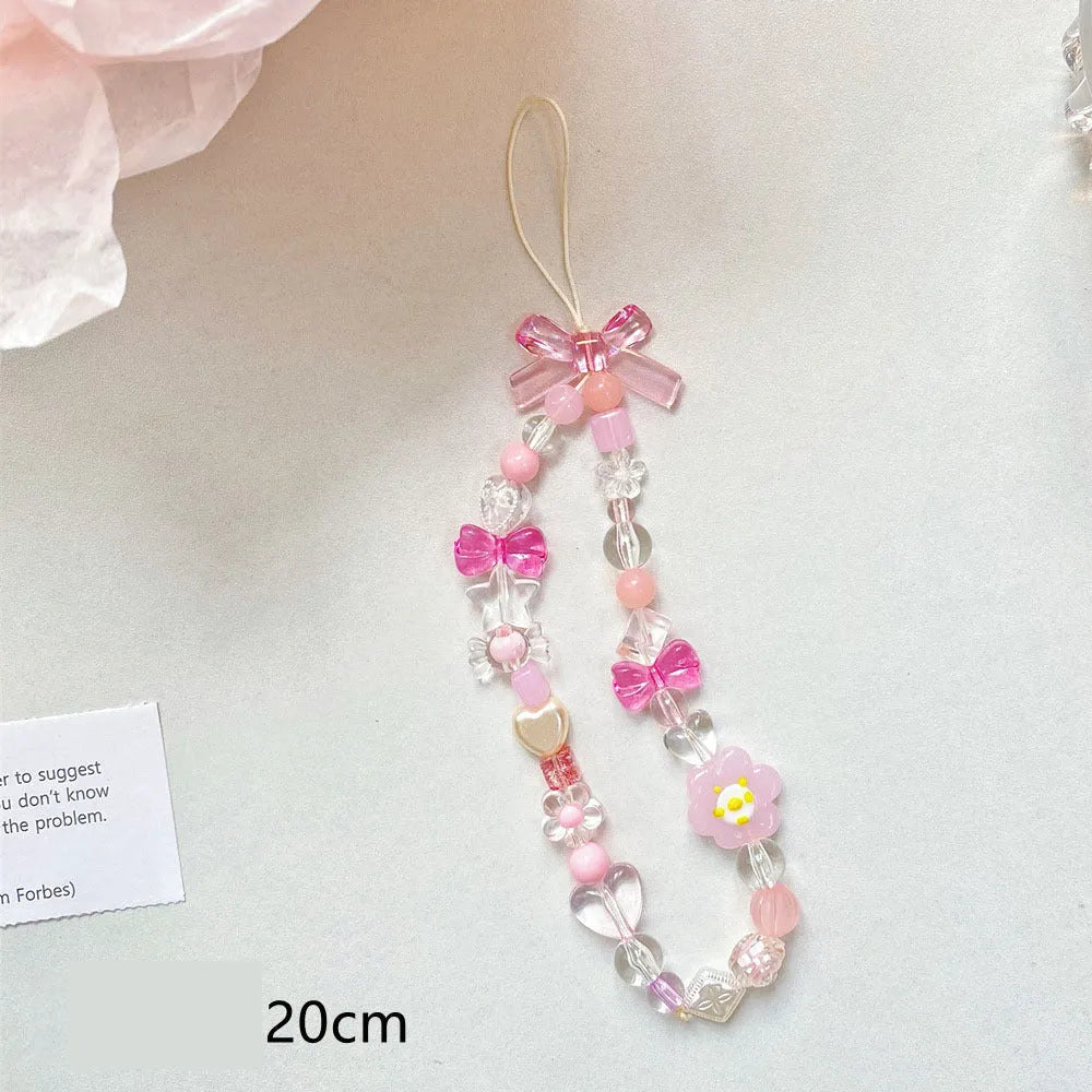Blue floral beaded mobile phone lanyard with an adjustable hand rope.