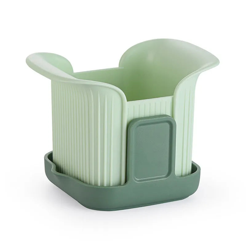 Green multifunctional vegetable chopper with stainless steel blades for dicing onions and slicing cucumbers.